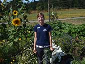 Woman standing in sunflower patch