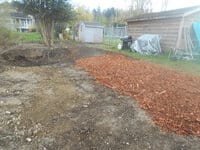 A row of woodchips covering an excavated area.
