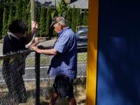 Richard and a volunteer install a deer fence